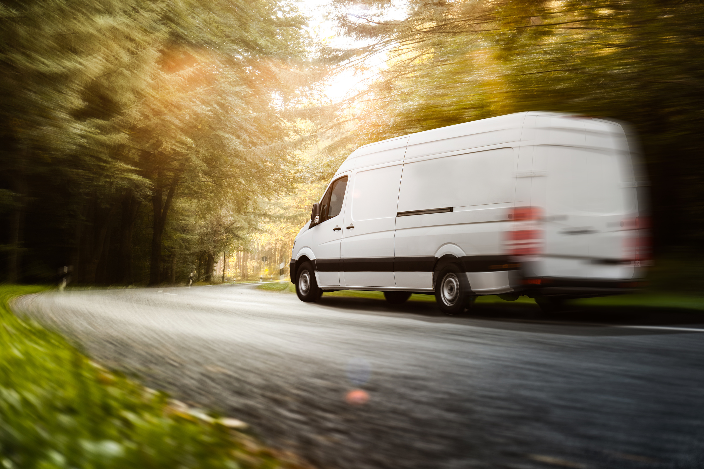 Delivery van drives on a road